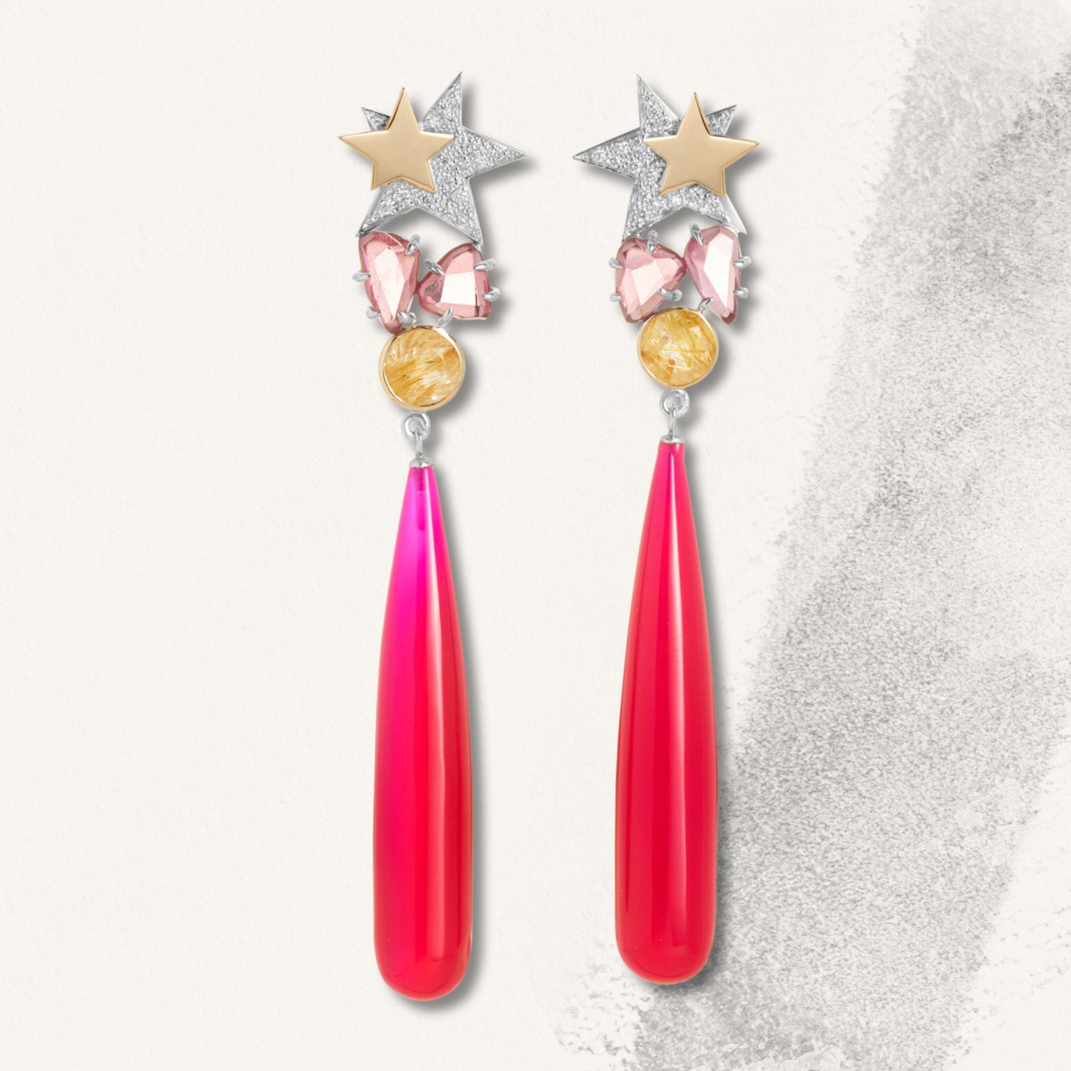 Earrings with gold and silver stars above two small pink stones on round yellow stones above a long neon pink stone