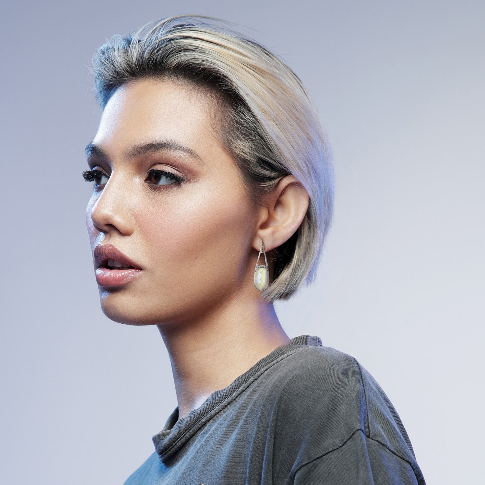 Woman wearing sterling sliver and faceted quartz earring