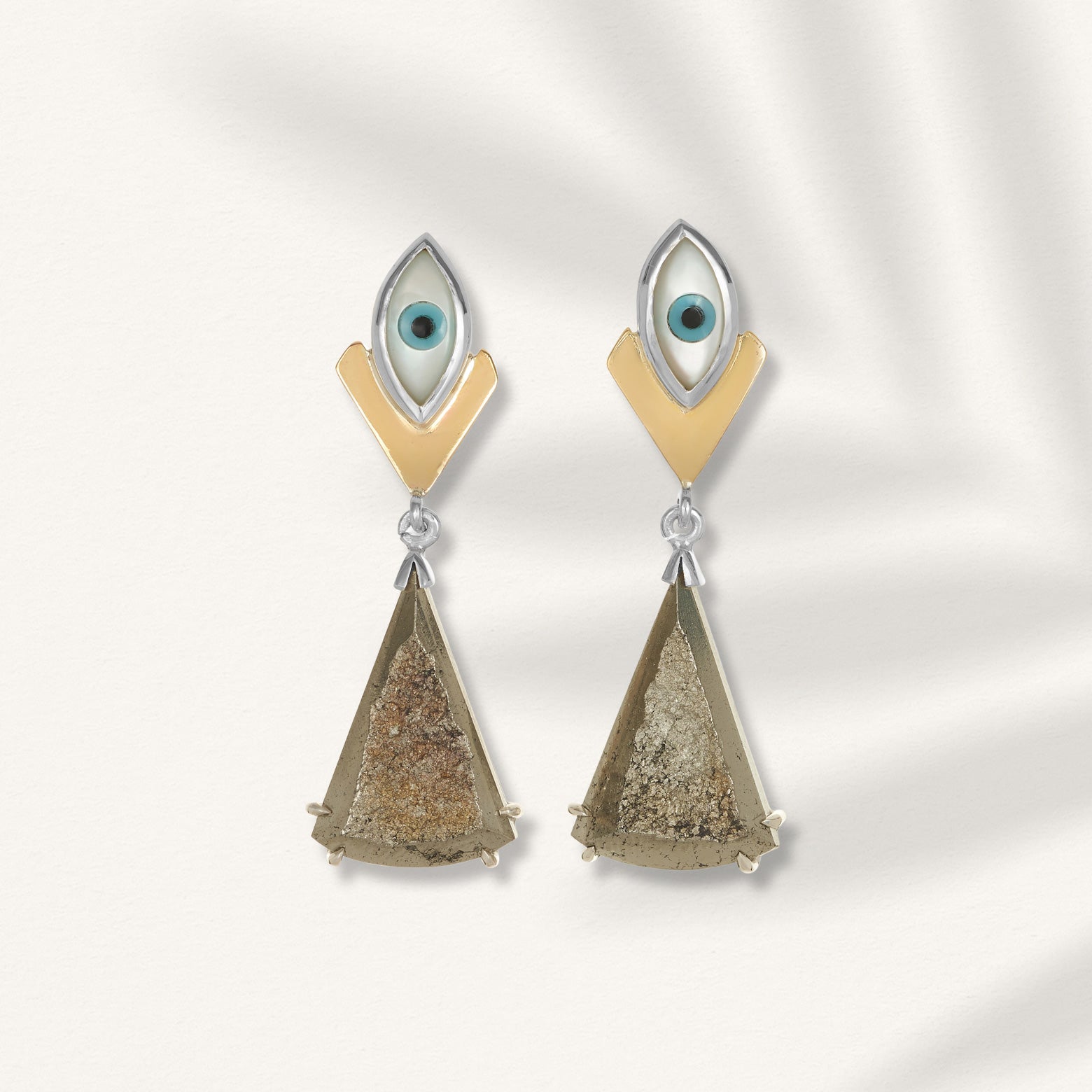 Kelly Woodcroft angel fish earrings feature an eye shaped stud connecting to a gold geometric dangle.