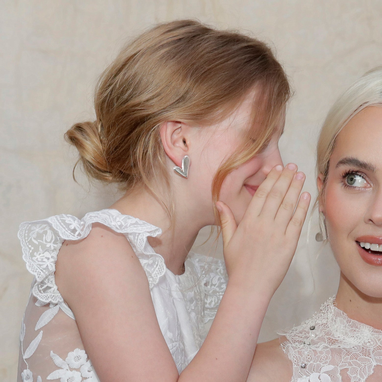 Flower girl wears mini asymmetric silver heart clip-on earrings