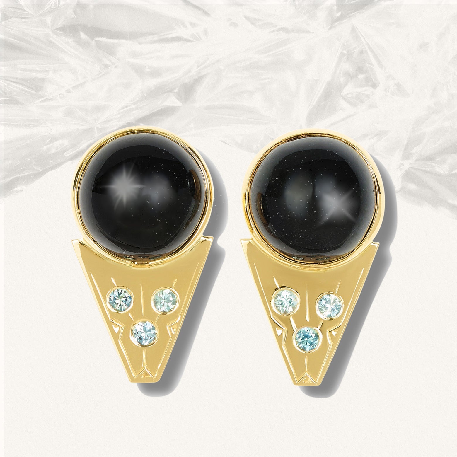 Yellow gold earrings with blue green sapphires and round black star diopside cabochon