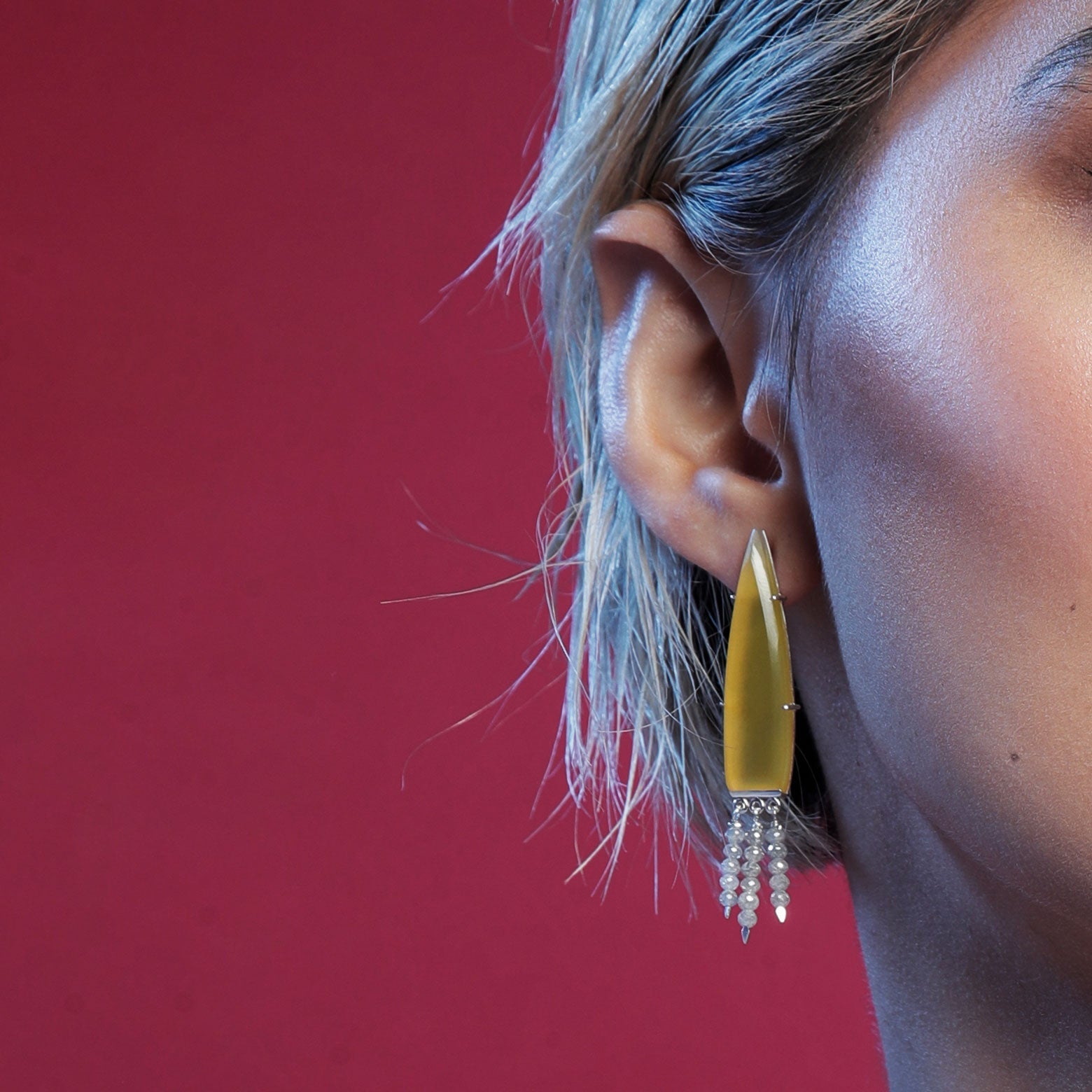 Close up woman wearing yellow chalcedony earring with diamond drops